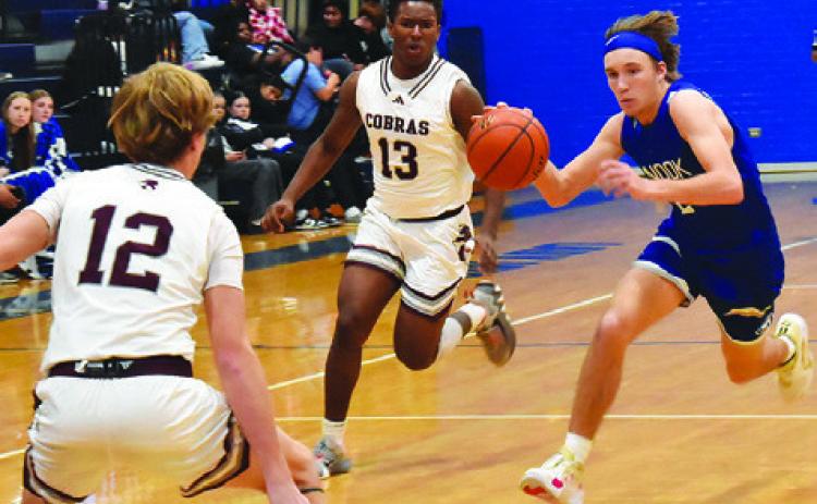 BRETT WITHEM OF Snook moves the ball down court against Vanderbilt Industrial. Snook lost 41-30. Tribune photo by Roy Sanders