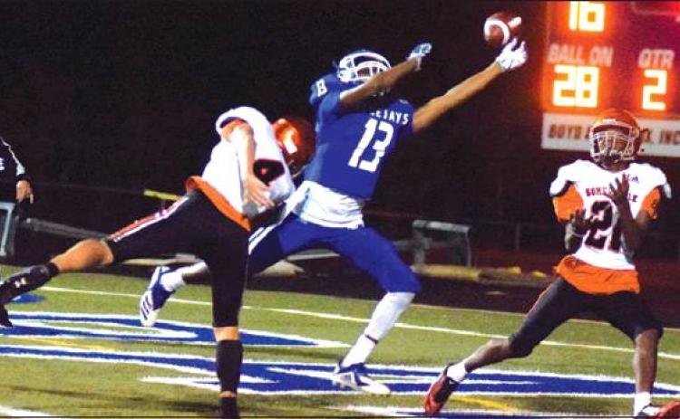 SNOOK’S JERMAINE KEARNEY TIPS THE BALL away from Somerville’s Dominic Tucker in the end zone, preventing a Somerville touchdown Friday night. Also pictured is Yegua wide receiver Johnny Legg. -- Tribune photo by Denise Hornaday