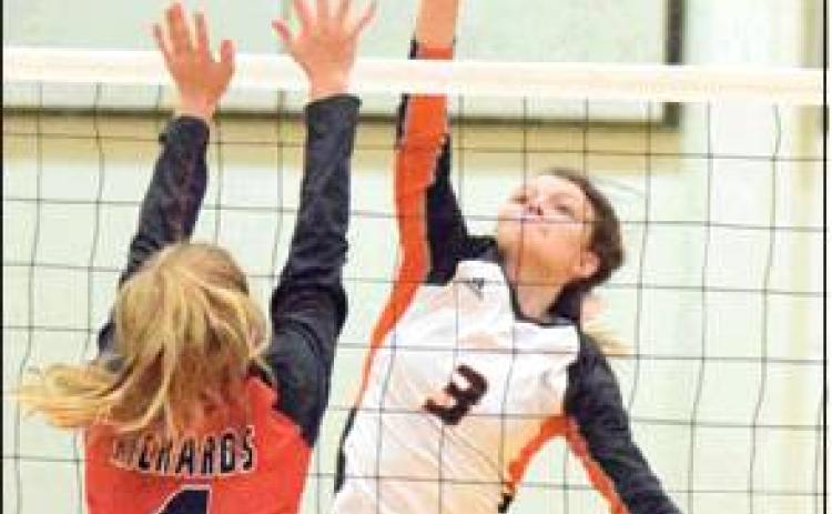 EMMA KOVASOVIC hit the ball over Richards’ Kylie Bates during Somerville’s win on Friday. -- Tribune photo by Denise Hornaday