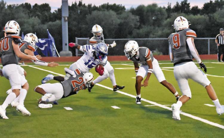 ROGELIO HERNANDEZ OF Caldwell makes a tackle against Crockett. The Hornets won the opener 47-32. Tribune photo by Roy Sanders