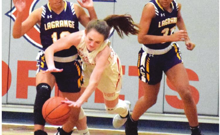 CALDWELL’S KATE URBANOVSKY trips over La Grange’s Kailee Jones during Tuesday night’s game at Hornet Gym. Number eight La Grange won the game. -- Tribune photo by Denise Hornaday