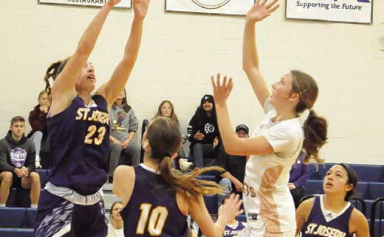 CALDWEL L ’ S LYDIA HICKS takes a shot over a couple of St. Joseph defenders during the Caldwell-St. Jo’s game last Friday. Tribune photo by Denise Squier