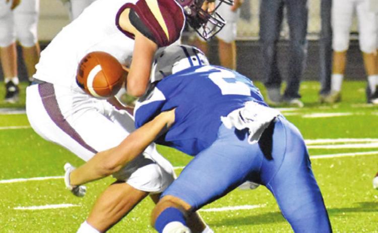 SNOOK’S LANCE LARA makes a jarring tackle and causes this fumble against Milano. -- Tribune photo by Roy Sanders
