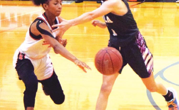 SOMERVILLE’S RA’MAYA CARTER passes the ball to a teammate during the Lady Yeguas’ win over Iola last Tuesday. Carter led Somerville in scoring with 19 points. -- Tribune photo by Denise Squier