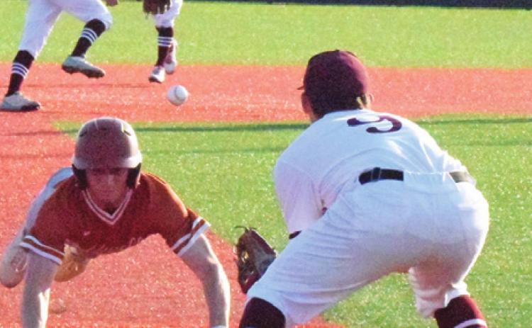 CALDWELL’S BRYCE BLINKA attempts to steal third base, trying to beat the throw by the Troy shortstop during the Hornets’ playoff series against the Trojans. -- Tribune photo by Denise Squier