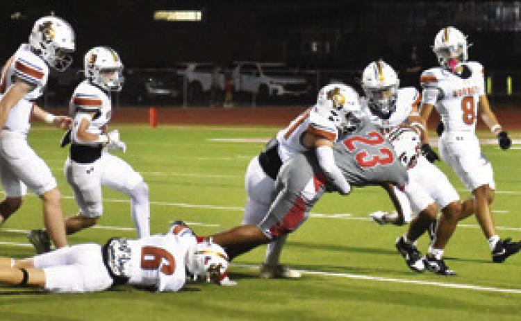 KYSON STRANGE AND Gus Naquin make a tackle in the season finale against Bellville. Tribune photo by Roy Sanders