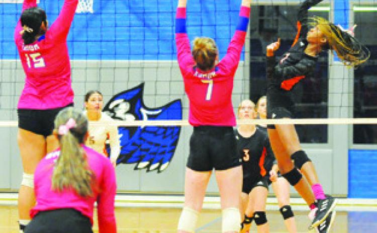 SOMERVILLE’S KARYS ELLIS gets a kill by hitting the ball between Snook’s Karla Lara and Kiley Price last Tuesday. Tribune photo by Denise Squier