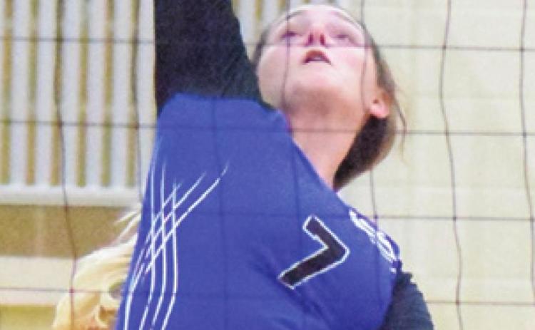 ALEXIS MACIK reaches to push the ball over the net during the Snook-Mexia match last week in the Leon Volleyball Tournament.
