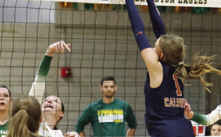 LUCY FERGUSON goes up to block the ball with the Lady Hornets ready on defense. Photo courtesy of Casey Faske