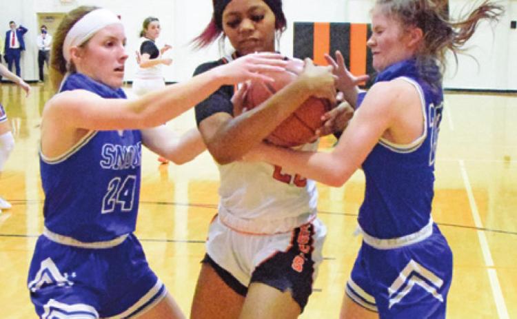 SOMERVILLE’S XADRIA MARTIN fights with Snook’s Jaycie Brisco and Kamree Walker for possession of the ball during the Snook-Somerville district game last Tuesday. -- Tribune photo by Denise Squier