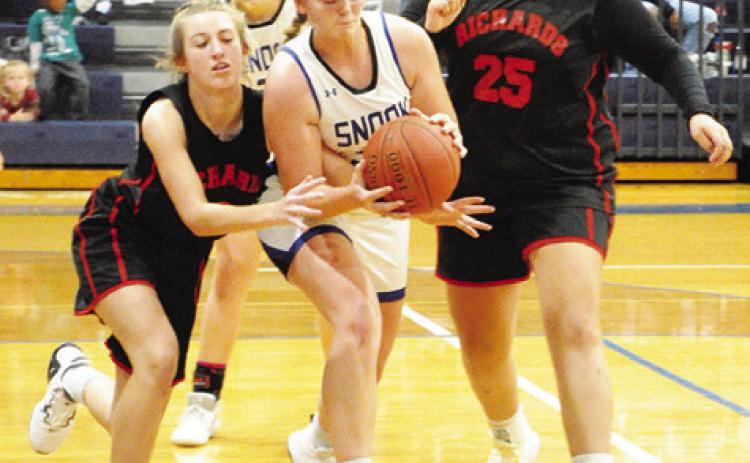 SNOOK’S ALEXIS MACIK FIGHTS WITH Richards players for possession of the ball during the Lady Jays’ win over the Lady Panthers last Tuesday. -- Tribune photo by Denise Squier