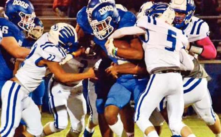 SNOOK’S ANTONIO LOTT, Konnor Eldridge and Jason Barker make a tackle against Bartlett. -- Tribune photo by Roy Sanders