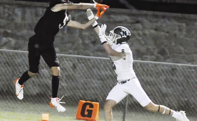 SOMERVILLE’S KYLE BROOKS reaches for this pass as this Normangee player defends. The Yeguas won 21-0 in their opener. Tribune photo by Denise Squier