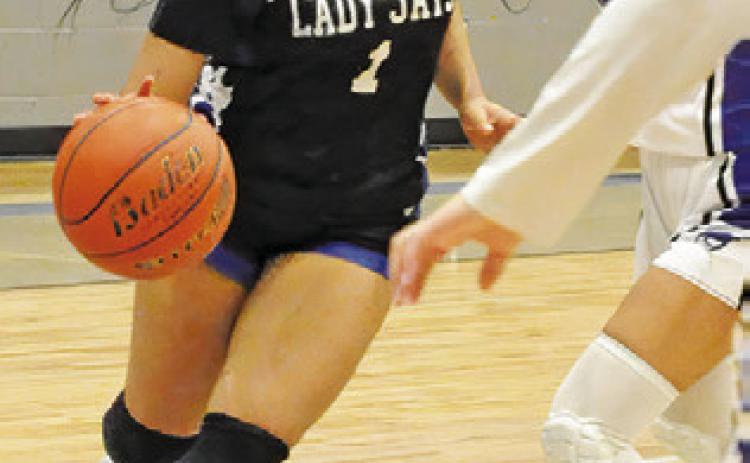 ALANA STRINGFELLOW drives the ball toward the basket during the Snook-Mumford game last Friday night in Mumford. Tribune photo by Denise Squier