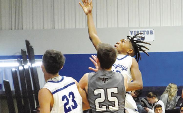 SNOOK’S JOHN CARR shoots against Fayetteville in last Tuesday’s game in Snook. -- Tribune photo by Denise Squier