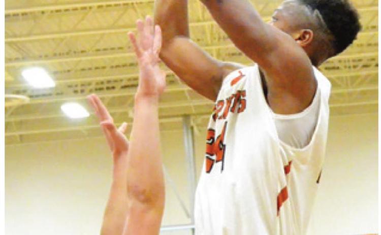 CALDWELL’S JUNIOR Mathis reaches high for this shot last week against La Grange. The Hornets won 48-45 in Caldwell.