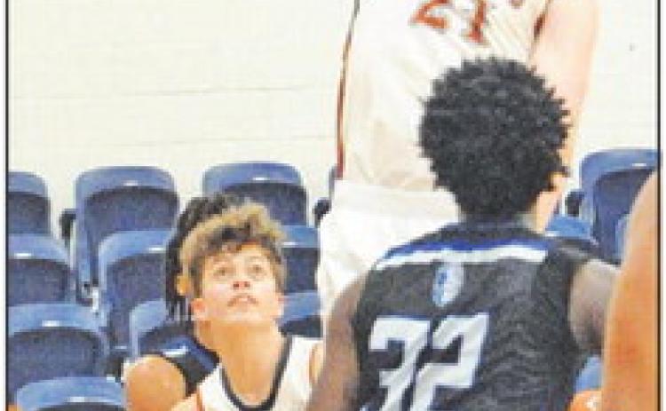 CALDWELL’S HARRISON Novak leaps high for this shot against Manor New Tech. -- Tribune photo by Denise Squier