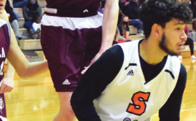 SOMERVILLE’S JULIAN Frayre looks to pass while Iola’s Brian Crosby jumps to defend.