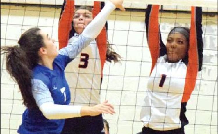 SNOOK’S NATALIE VACHA tries to hit the ball past Somerville’s Emma Kovasovic and Xadria Martin during last Tuesday night’s Snook-Somerville district match. -- Tribune photo by Denise Hornaday
