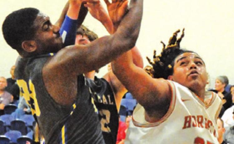 DEE MORRIS OF Caldwell fights for the ball against Rockdale in the Hornets’ win.