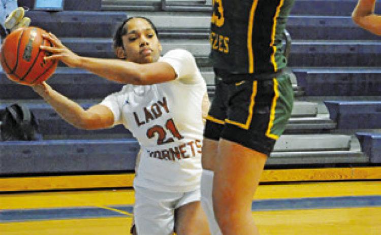 AVELYNN O’RILEY looks to pass the ball during the Caldwell-Lexington game at the Snook Lady Jays Basketball Tournament.