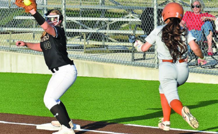JAELYNN GEST TRIES TO outrun the throw to first during the Caldwell-Giddings game last Friday night at Weiss Field. Tribune photo by Roy Sanders