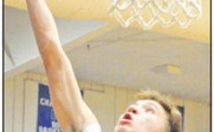 BRETT WITHEM OF the Snook Bluejays takes a shot in the home game against Mumford. -- Tribune photo by Denise Squier