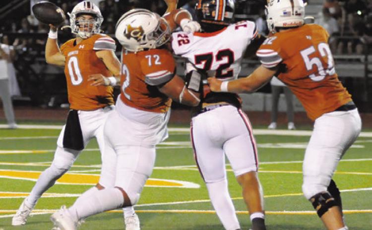 CALDWELL’S COY BECKA passes against Smithville while Preston Supak and Chase Clark block. Caldwell won 49-24. Tribune photo by Denise Squier
