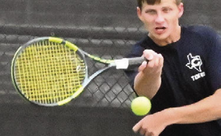 BRYCE BARR keeps the ball alive during a boys doubles match at the Caldwell-Franklin team tennis match last week. Tribune photo by Denise Squier