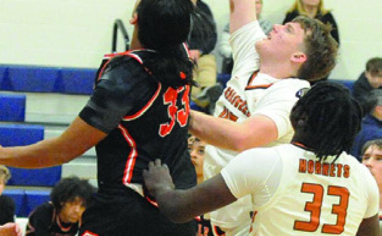 MATTHEW BAASEN fights for the ball. Also pictured is Jegorean Hewitt. Tribune photo by Denise Squier