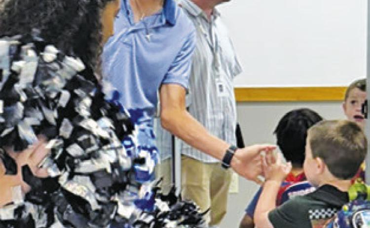 SNOOK’S BRETT Withem greets students during a sendoff prior to his appearance at the state golf tournament in Austin.