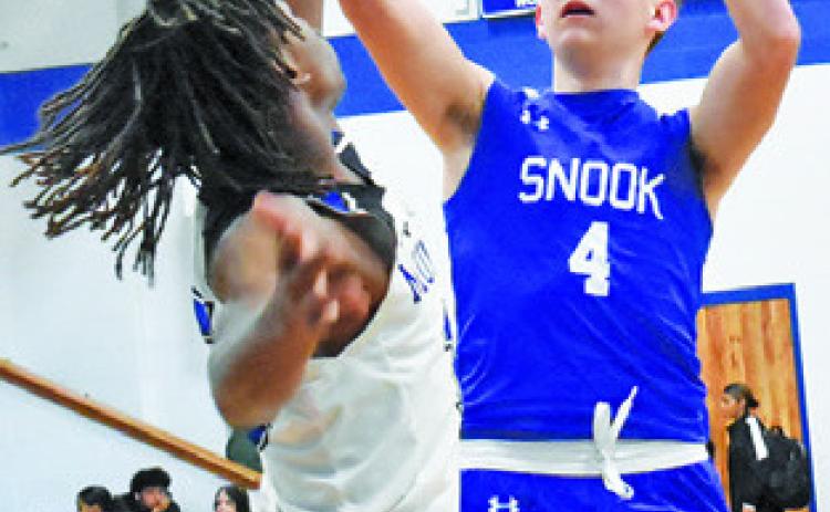 JUSTIN HRUSKA takes a shot against Mumford. -- Tribune photo by Roy Sanders