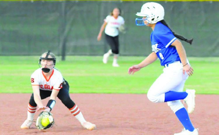 SOMERVILLE SHORTSTOP AUBREY Flencher fields a ground ball while Snook’s Ashley Quevedo runs from second to third.