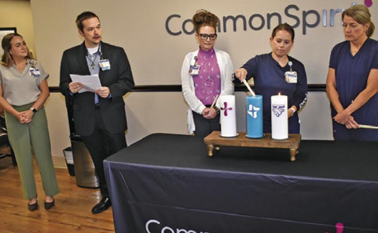 CANDLES ARE LIT at the blessing ceremony at CommonSpirit St. Joseph Hospital -- Burleson County on Monday. Pictured from left are Erin Marietta, Chaplain Scott Floyd, Jo Johnson, Erin Gaas and Heather Page. Local leaders and hospital staff also attended. Tribune photo by Roy Sanders