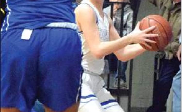 NATALIE VACHA looks to pass around a Navasota defender during the Snook-Navasota game on Friday in Snook. Snook won the game 40-19. -- Tribune photo by Denise Hornaday