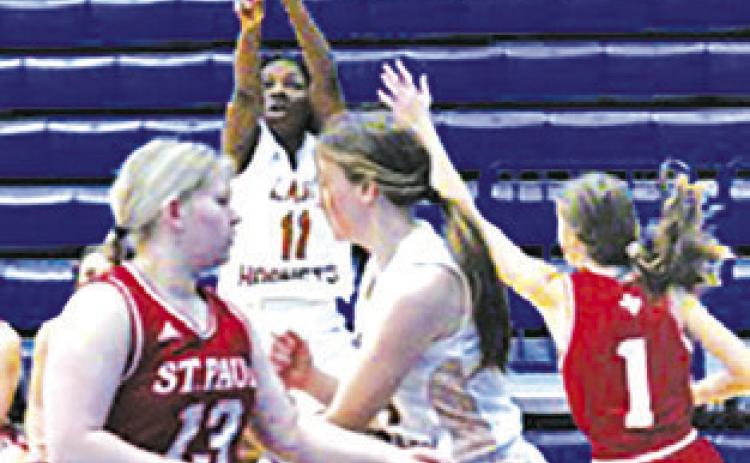 AMOREE DENSON takes a shot in the first quarter against St. Paul at the Yoakum Tournament. -- Photo by Mark Lube/Shiner Gazette