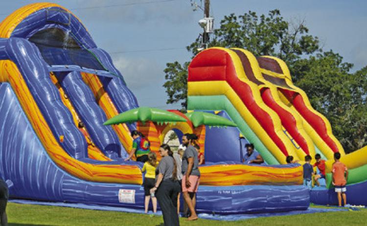 AREA CHILDREN ENJOYED WATERSLIDES and other fun activities at the Harrie P. Woodson Memorial Library’s end of summer water party at J.E. Hejl Park at Davidson Creek. Tribune photo by Kimberly Hutcheson