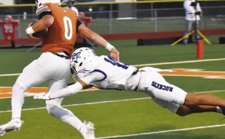 COY BECKA ELUDES this Robinson defender. Caldwell lost to the Rockets 31-20. Tribune photo by Roy Sanders