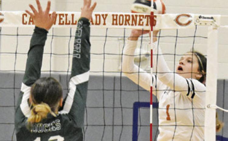 CALDWELL’S ASHLYN KELLUM pushes the ball over the net and over Taylor’s Camryn Nunamaker during the Lady Hornet-Lady Duck match on Friday afternoon. -- Tribune photo by Roy Sanders