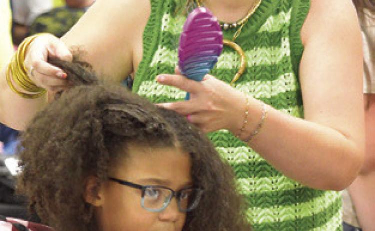 THE BACK TO SCHOOL Blast event not only gave out school supplies to area students, they were able to get free hair cuts and hair styles. Tribune photo by Denise Squier