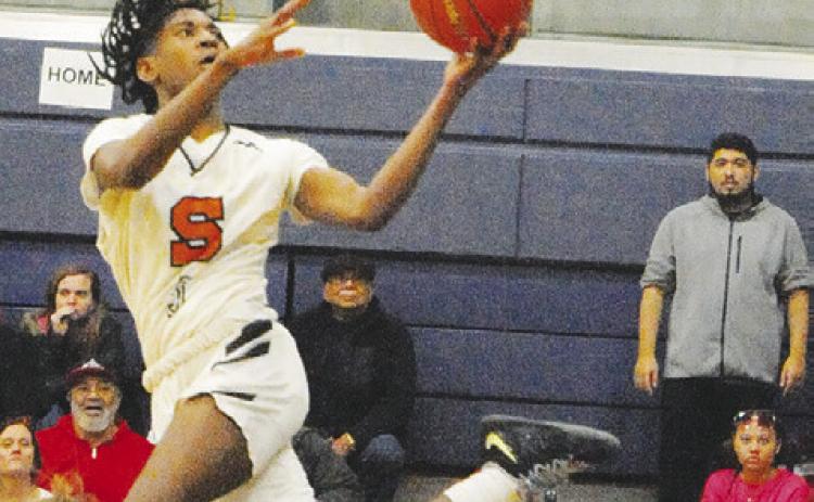 BRANDYN CARTER LUNGES for this shot against Iola. Somerville won 57-53. -- Tribune photo by Denise Squier