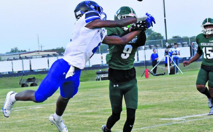 SNOOK’S JOHN CARR and a Normangee defender go for the ball in last Friday night’s game in Normagnee. Tribune photo by Roy Sanders